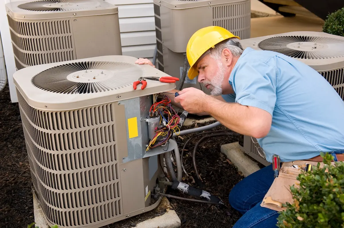 Mature Repairman works On Apartment Air Conditioning Unit