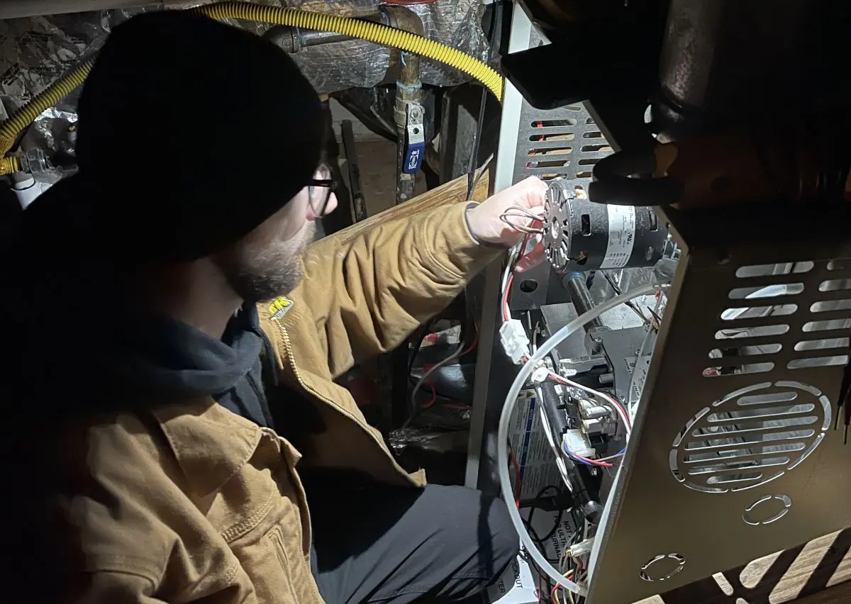 Panther HVAC team member repairing AC units