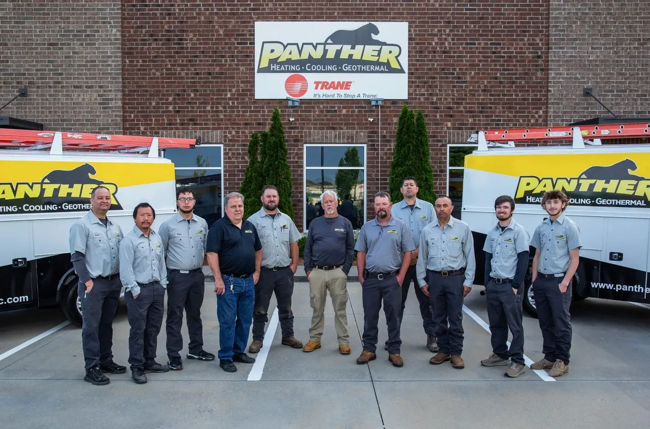 The professional crew of Panther Heating, Cooling, and Geothermal stands together for a team photo in front of the headquarters.