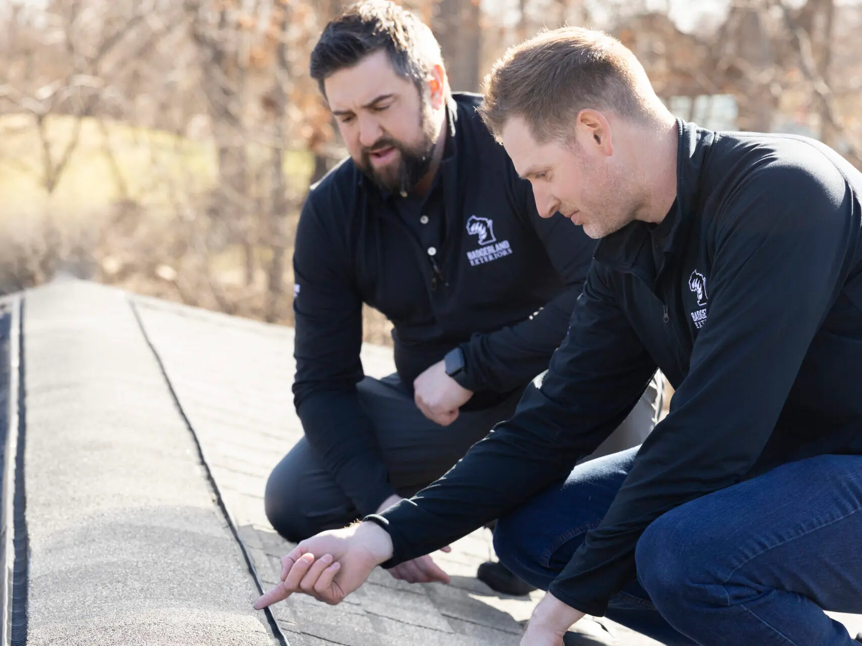 roof inspection services two workers inspecting shingles lifting roof