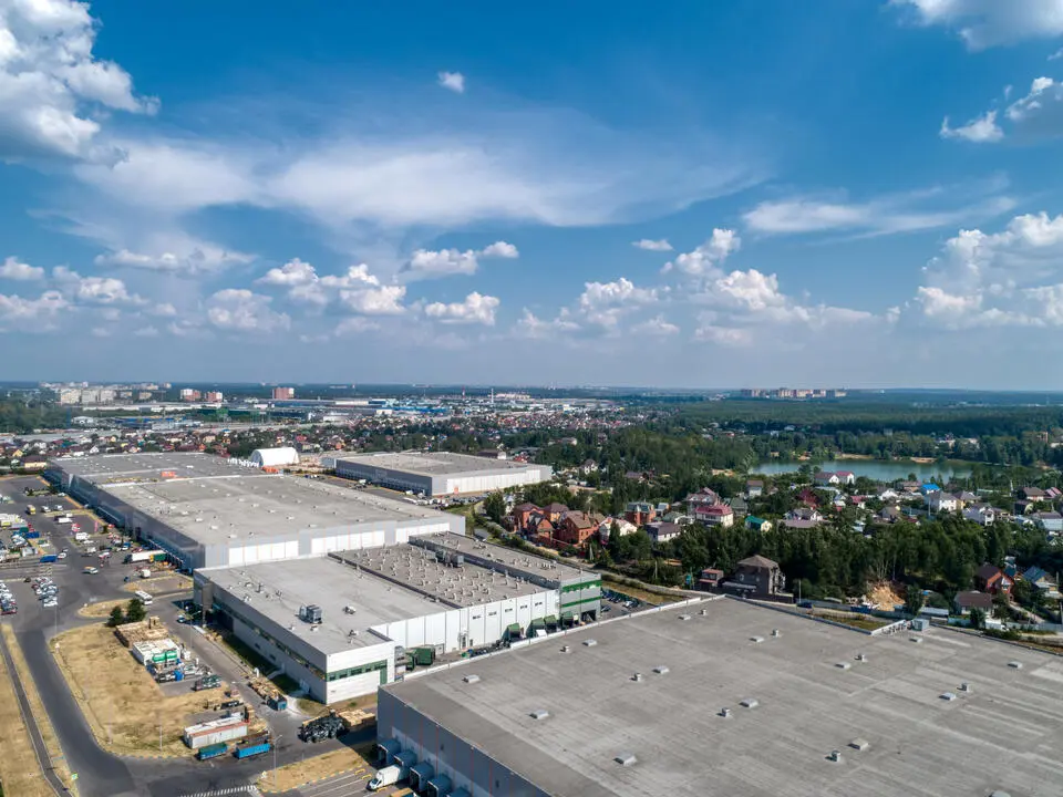 commercial buildings with flat roofs with city and skyscape in background