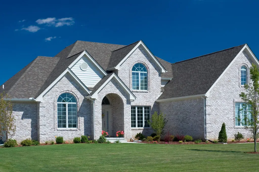 Grey brick home in Madison, WI with asphalt shingles