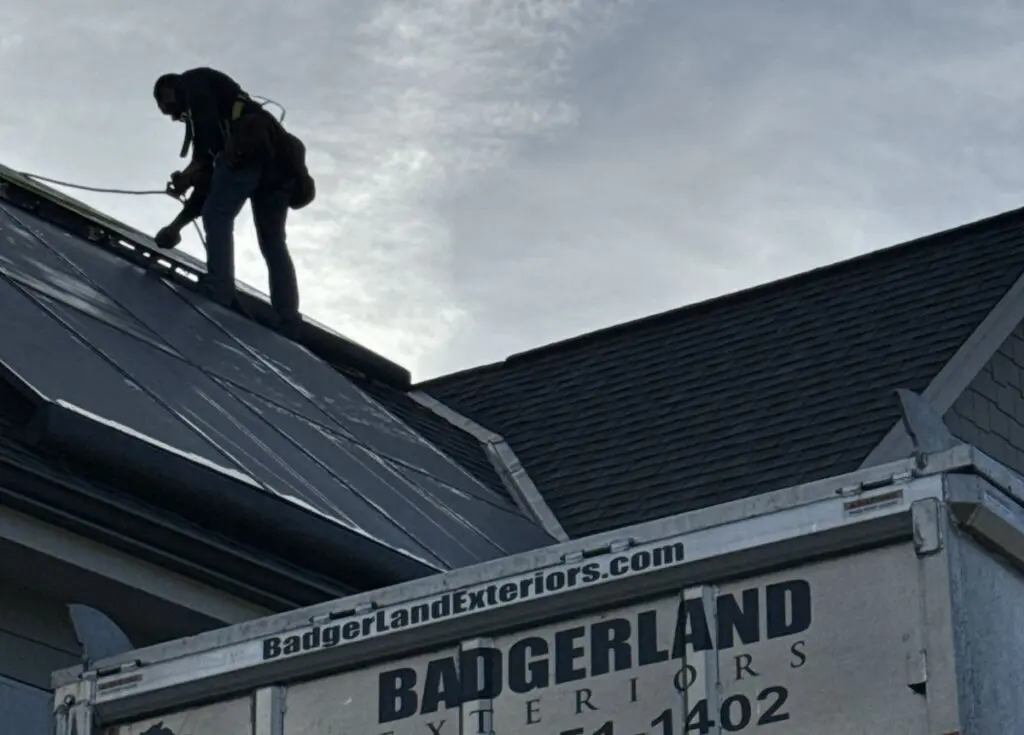 Badgerland Exteriors team working on a roof to install solar panels