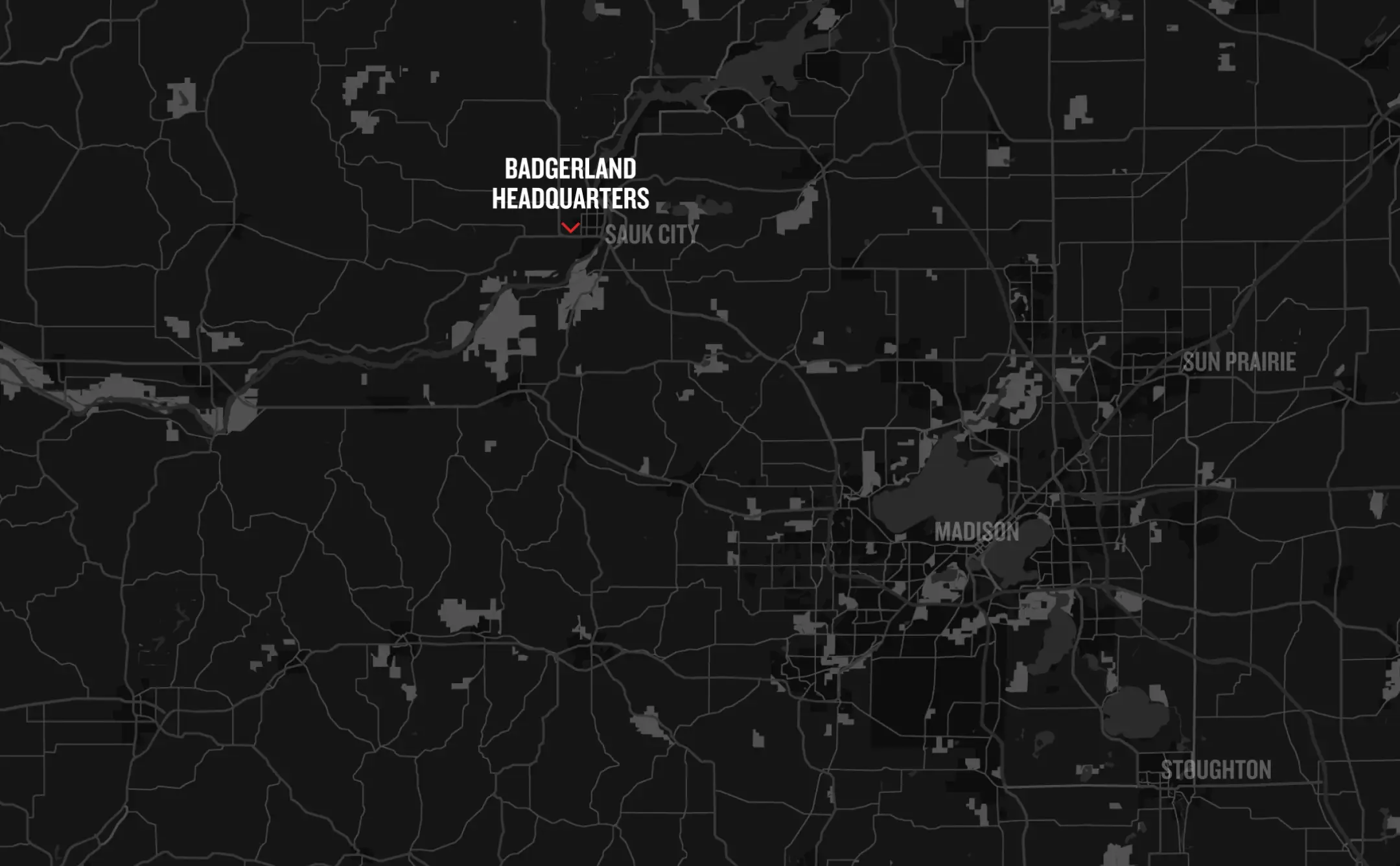 A dark map highlighting areas around Madison, Wisconsin. "Badgerland Headquarters" is labeled near Sauk City. Roads and geographic features are faintly visible on the black background.