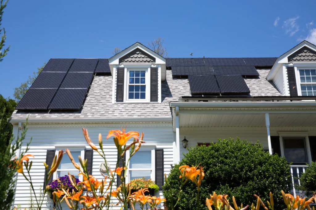 front of home with solar panels attached on asphalt shingles
