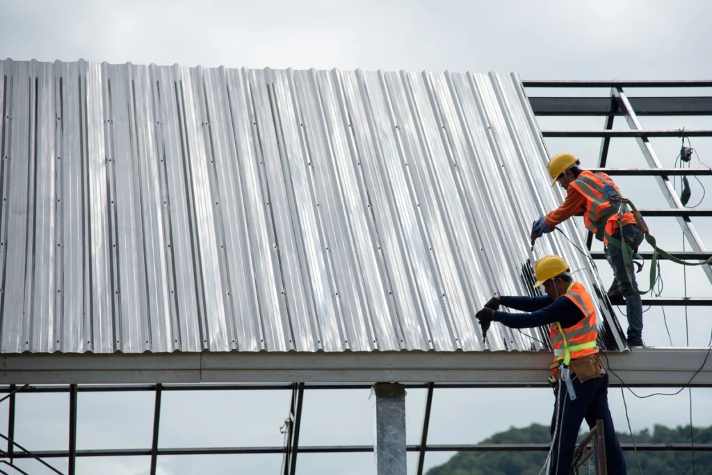commercial roofing sun prairie workers installing metal roof on commercial building