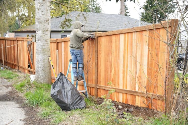 Cool Cat Fence working on a cedar fence
