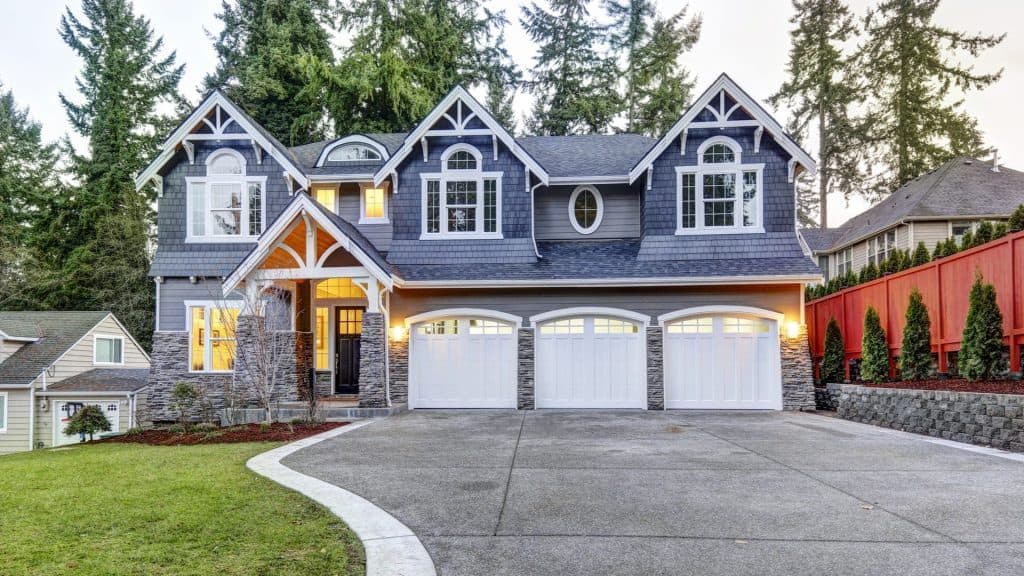 Beautiful Victorian-style house with fresh blue paint and white trim, showcasing professional painti.