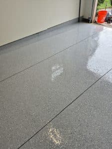 Polished concrete floor with a glossy finish near a building wall.