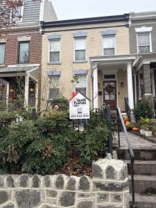 Beautiful painted house exterior with vibrant colors and well-maintained garden.