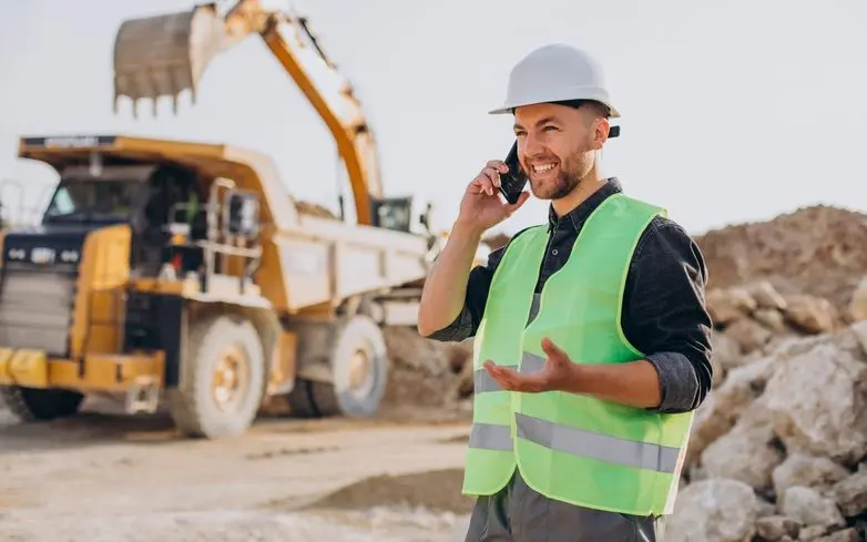 construction worker speaking on mobile phone