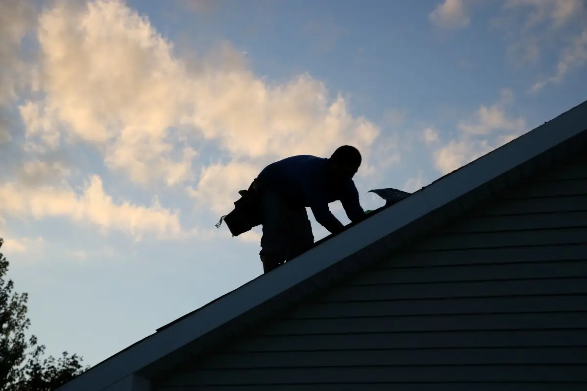 First Fruits roofer working on a roof