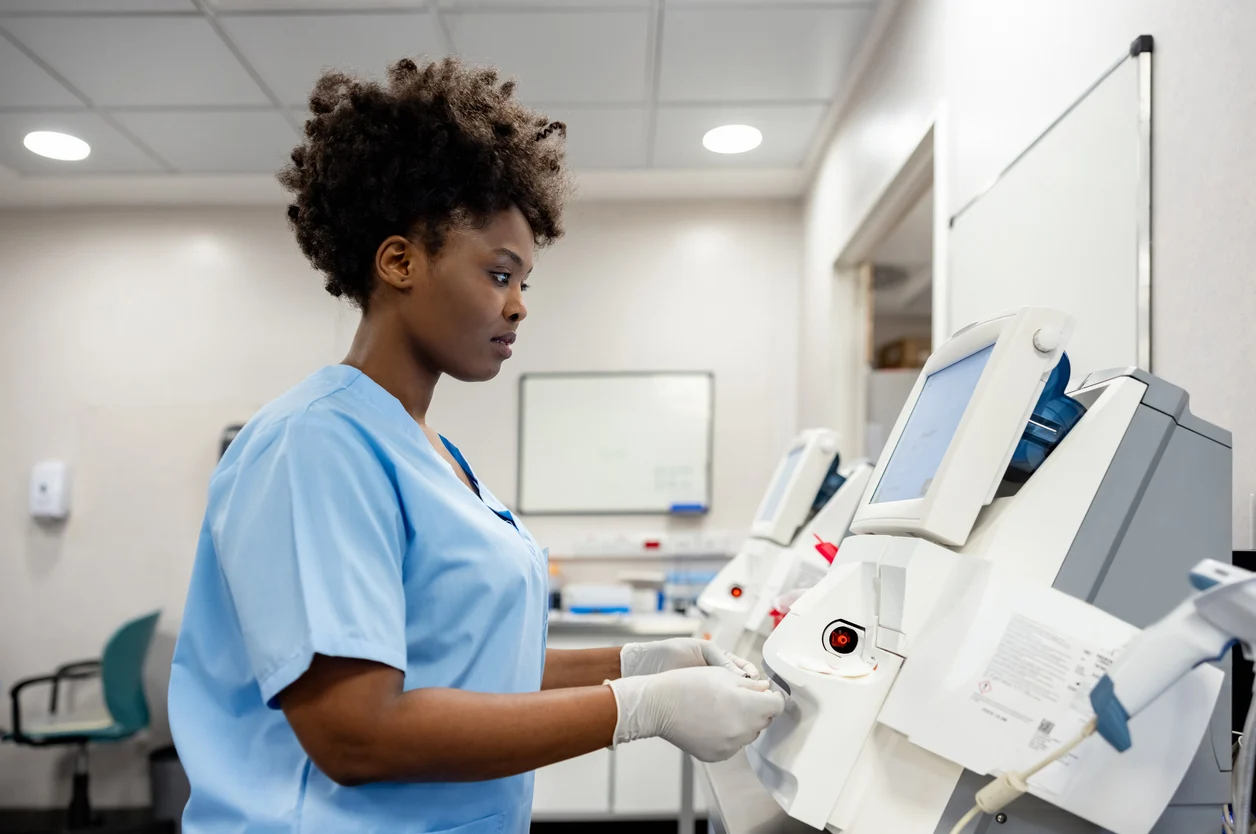 African American female doctor technician working at the laboratory analyzing blood samples â healthcare and medicine
