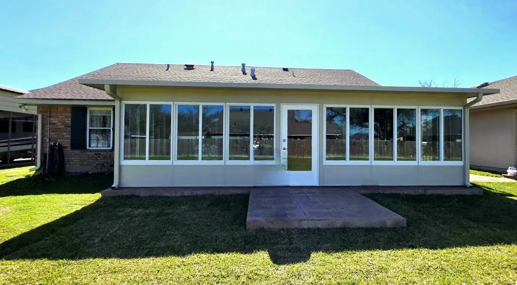 Insulated sunroom with large windows and a modern design, enhancing year-round comfort in a New Orleans home.