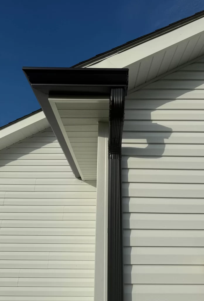 Seamless aluminum gutter system installed on a residential home, showcasing precision craftsmanship and protection against water intrusion.
