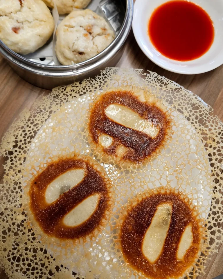 Meimei's Dim Sum House, Grovetown, GA: chinese dim sum spread: pan-fried lacy crepe pockets (jian bing/crispy dumplings) with dark sauce filling, steamed buns in bamboo steamer, small dish of chili oil
