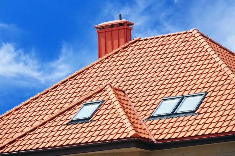 the roof of the house of red tiles on background of blue sky