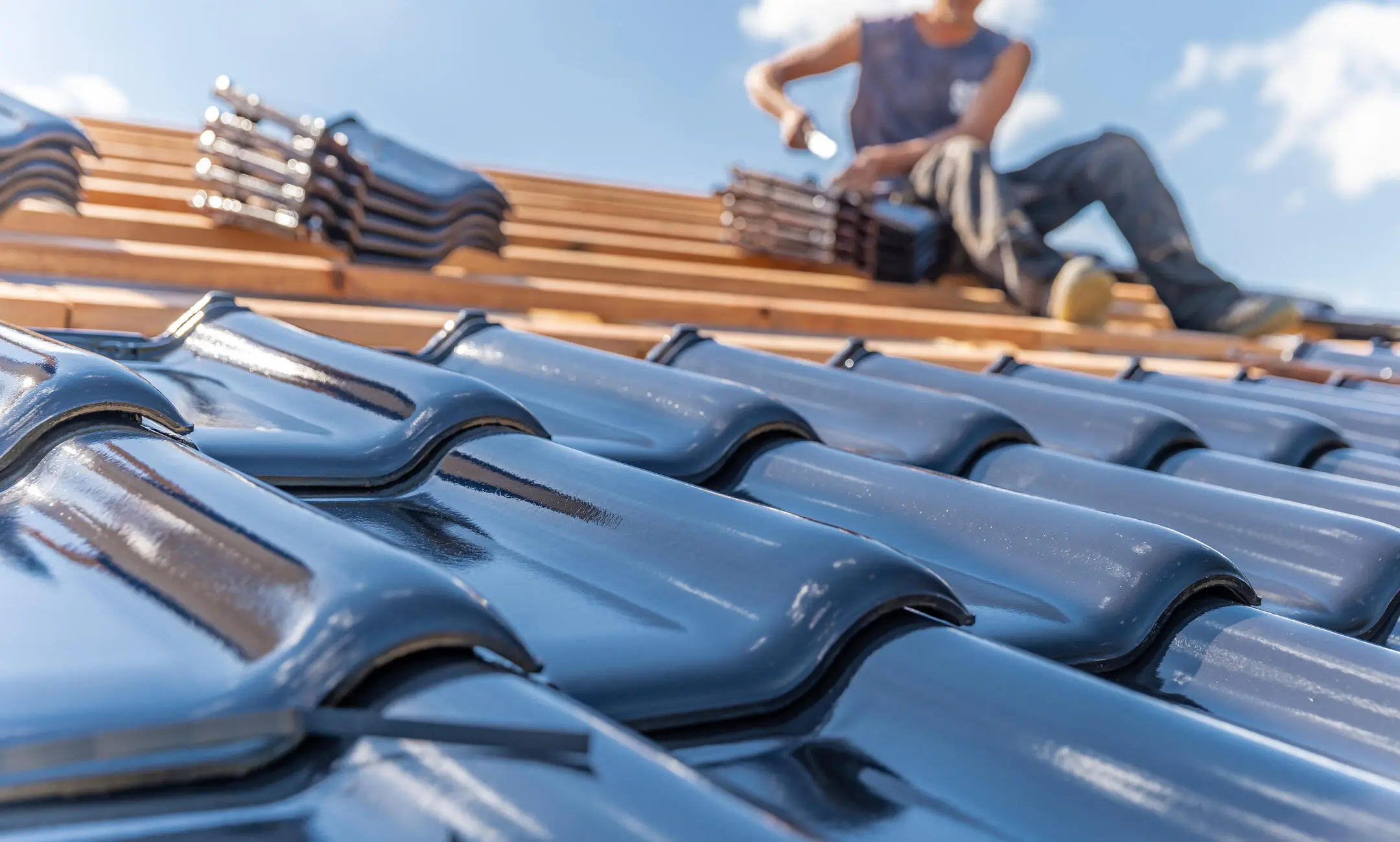 ceramic roof tiles-close up of ceramic tiles being installed on a house roof