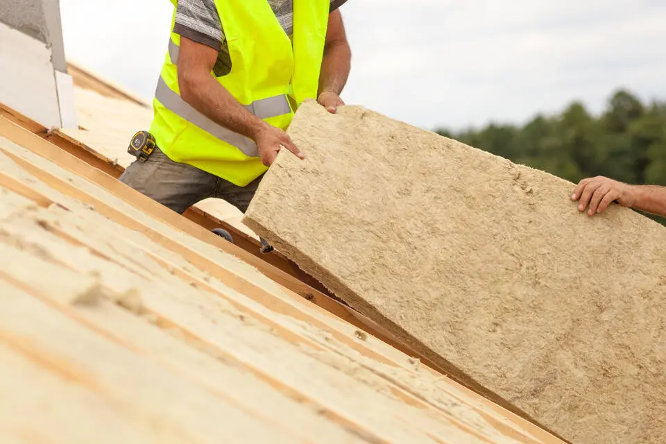 energy efficient roofing-roofers installing roof insulation