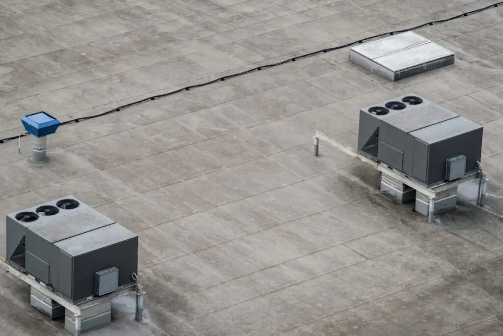 The external units of the commercial air conditioning and ventilation systems are installed on the roof of an industrial building. commercial roof cleaning