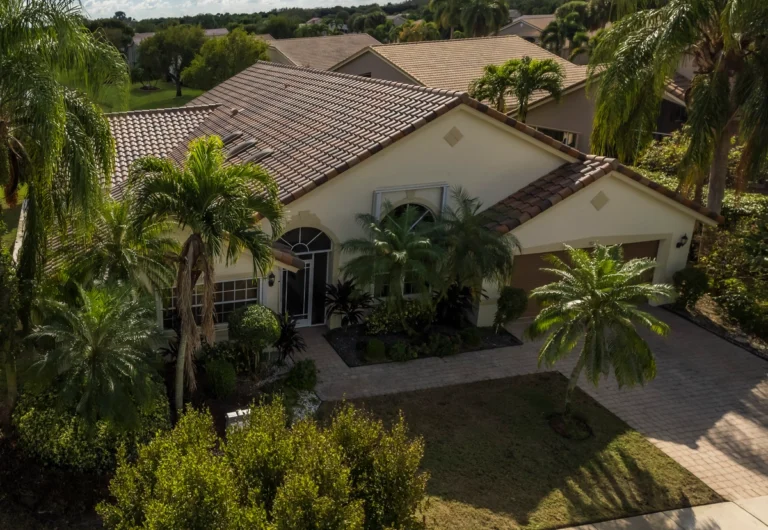 Yellow Florida home with tile roof after a roof repair by Distinctive roofing