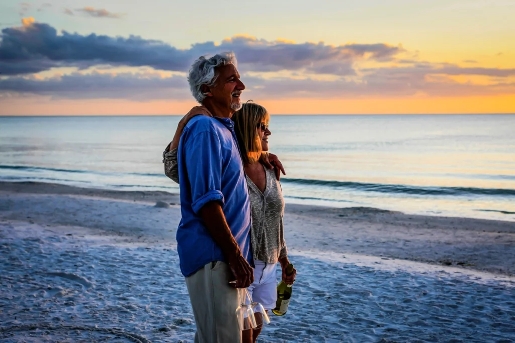 florida retired homeowners on beach enjoying stress-free sunset