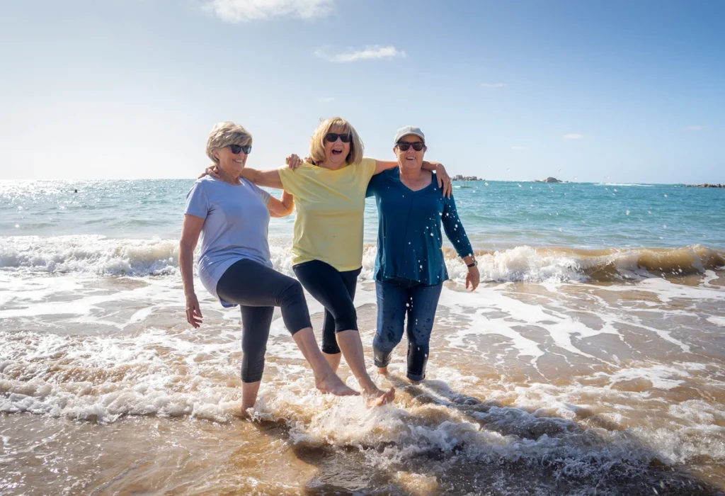 retired women laughing on florida beach
