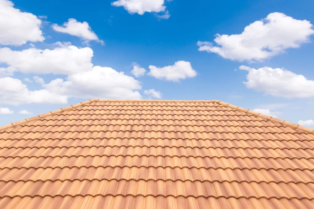 red roof tiles on new house and cloudy sky