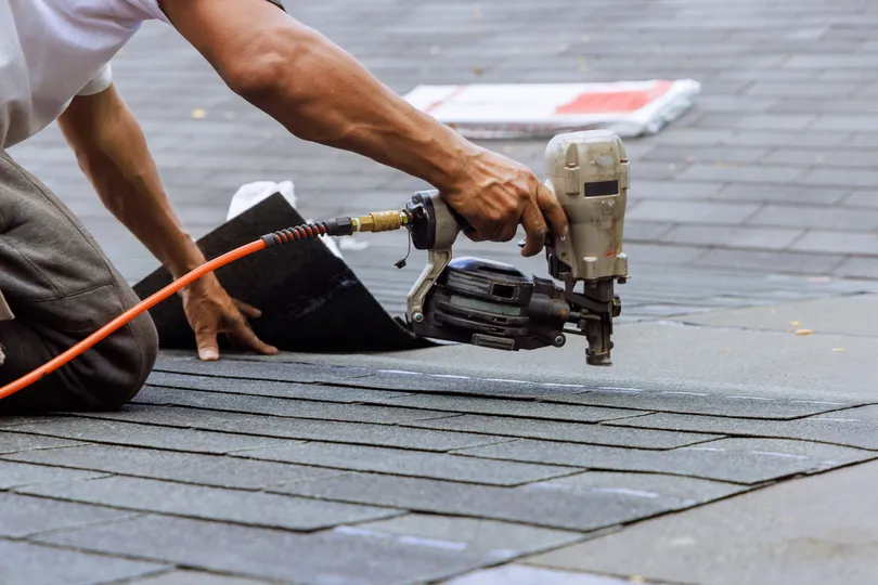 technician installing shingle