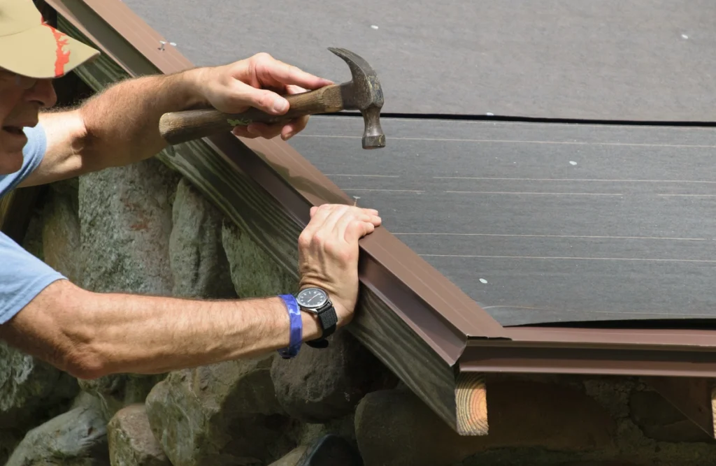 man installing drip edge flashing