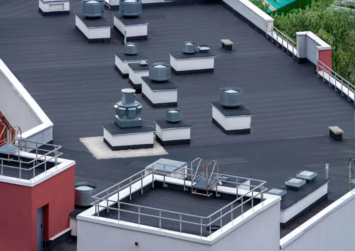 apartment complex with black roof and vents