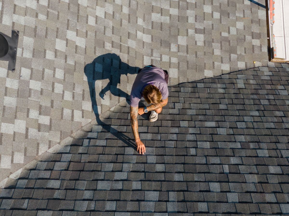 Licensed roofing project manager performing a residential roof inspection in Minneapolis