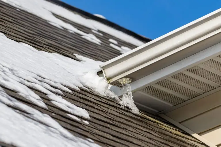 Melting snow on roof of s Woodbury house has formed ice on shingles and icicles hanging from gutter