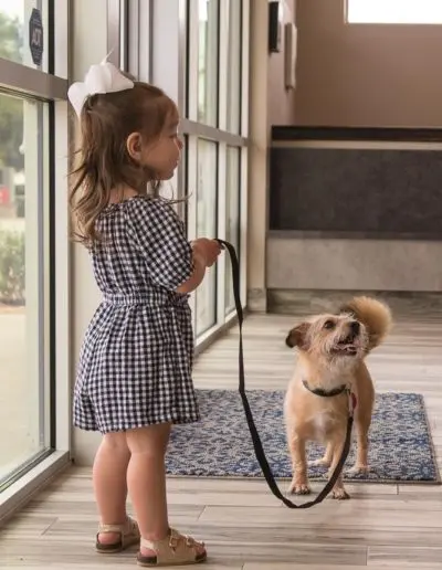 girl walking dog on leash