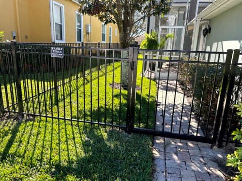 Installed black aluminum fence with gate in Tampa