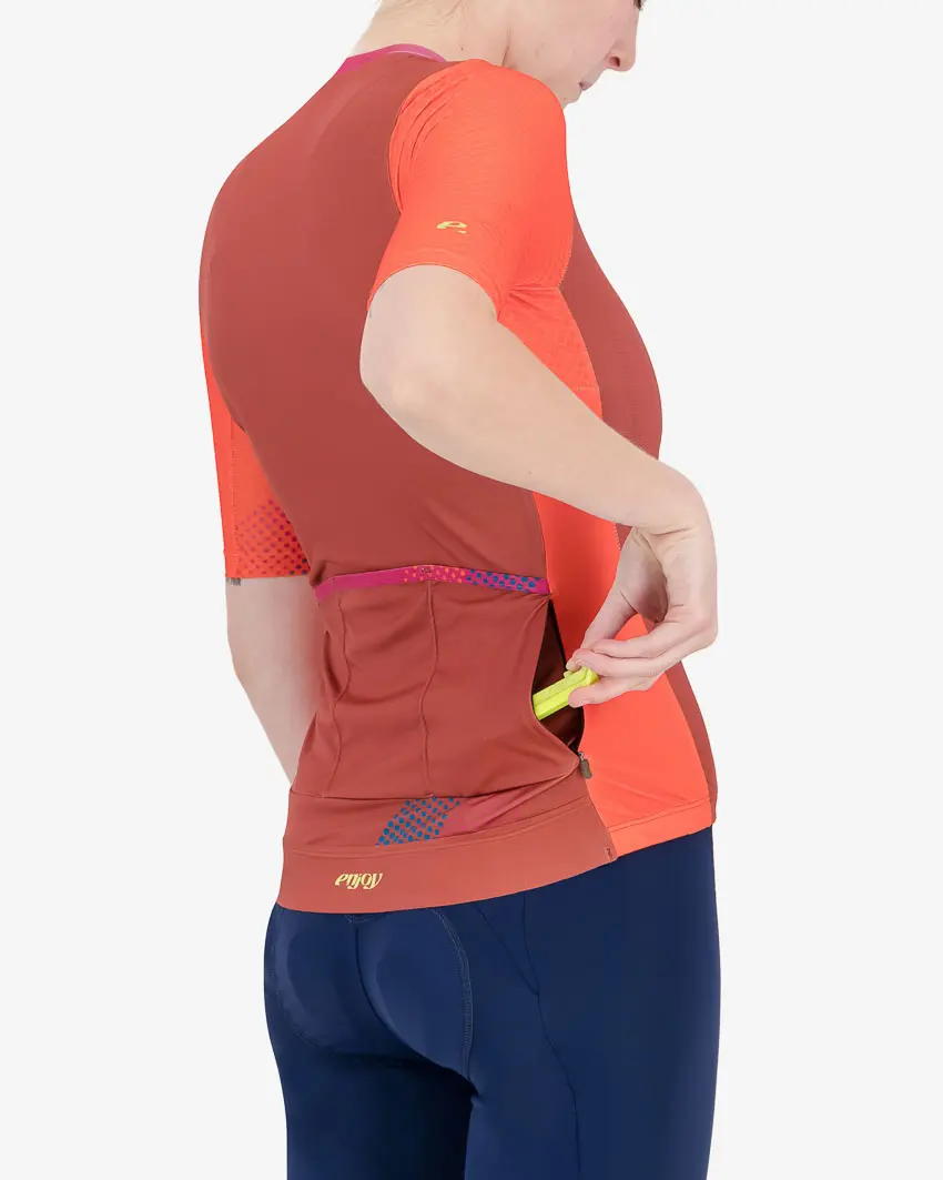 Pocket of the Enjoy ProXision womens cycling jersey in the Ascendant orange design from Enjoy.cc