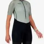 Side view of the women's sleeved triathlon suit in a green and black design made by enjoy.cc