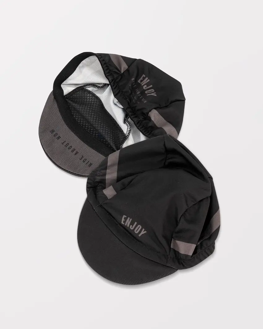 Flat lay of the mens cycling cap in the Semester black DriFit design made by enjoy.cc