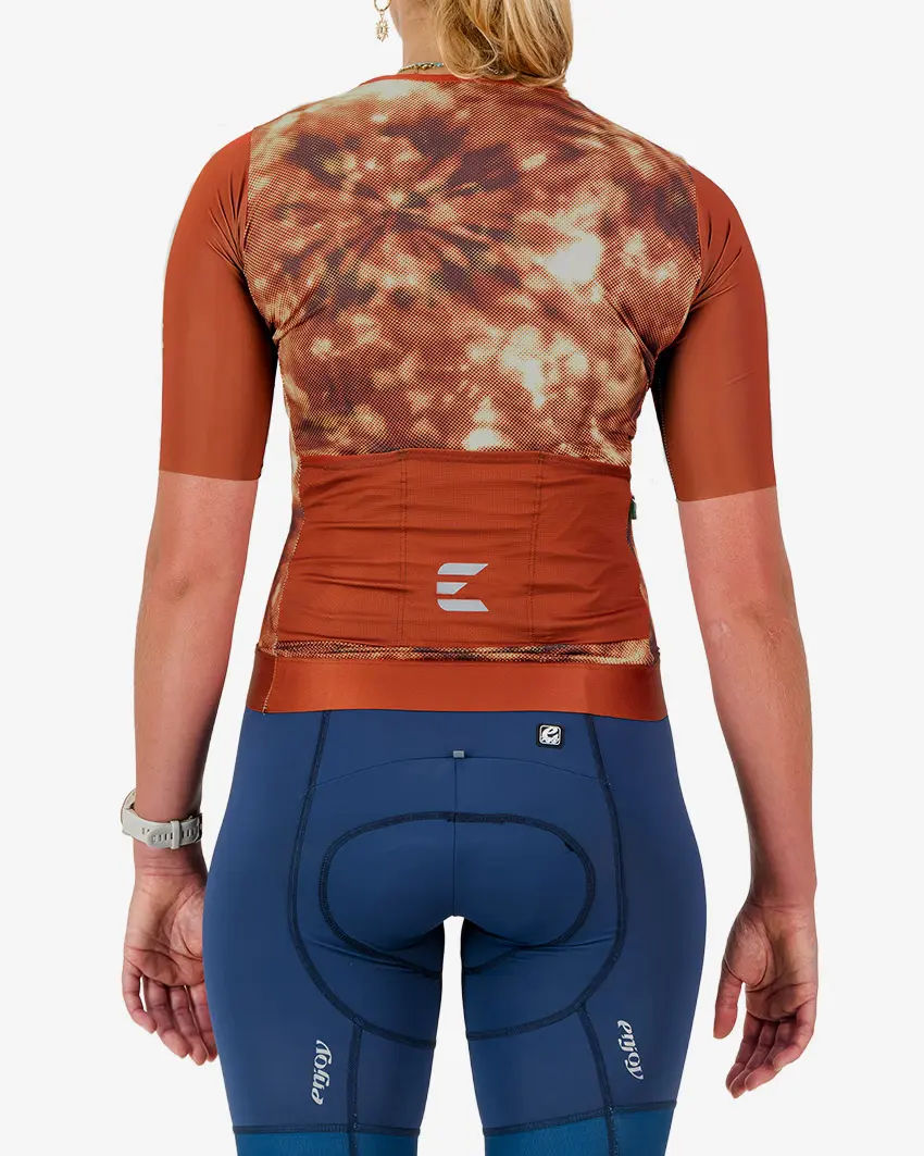 Back view of the ProXision women's cycling zipless jersey in a rust tie-dye design made by enjoy.cc