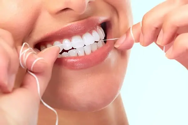 Woman Flossing