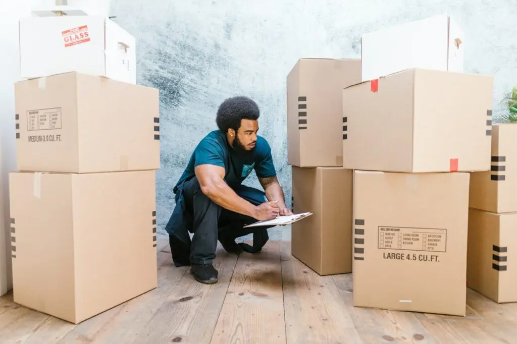 man looking at boxes