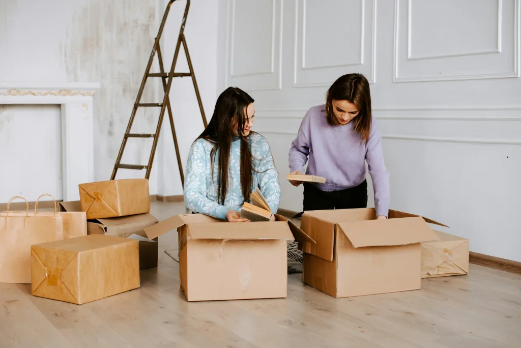 Eco-Friendly Moving Tips: How to Minimize Waste and Help the Environment During Your Relocation 5 women packing things in moving boxes, Eco-Friendly