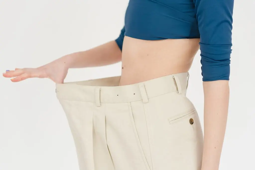 woman wearing oversized pants after weight loss