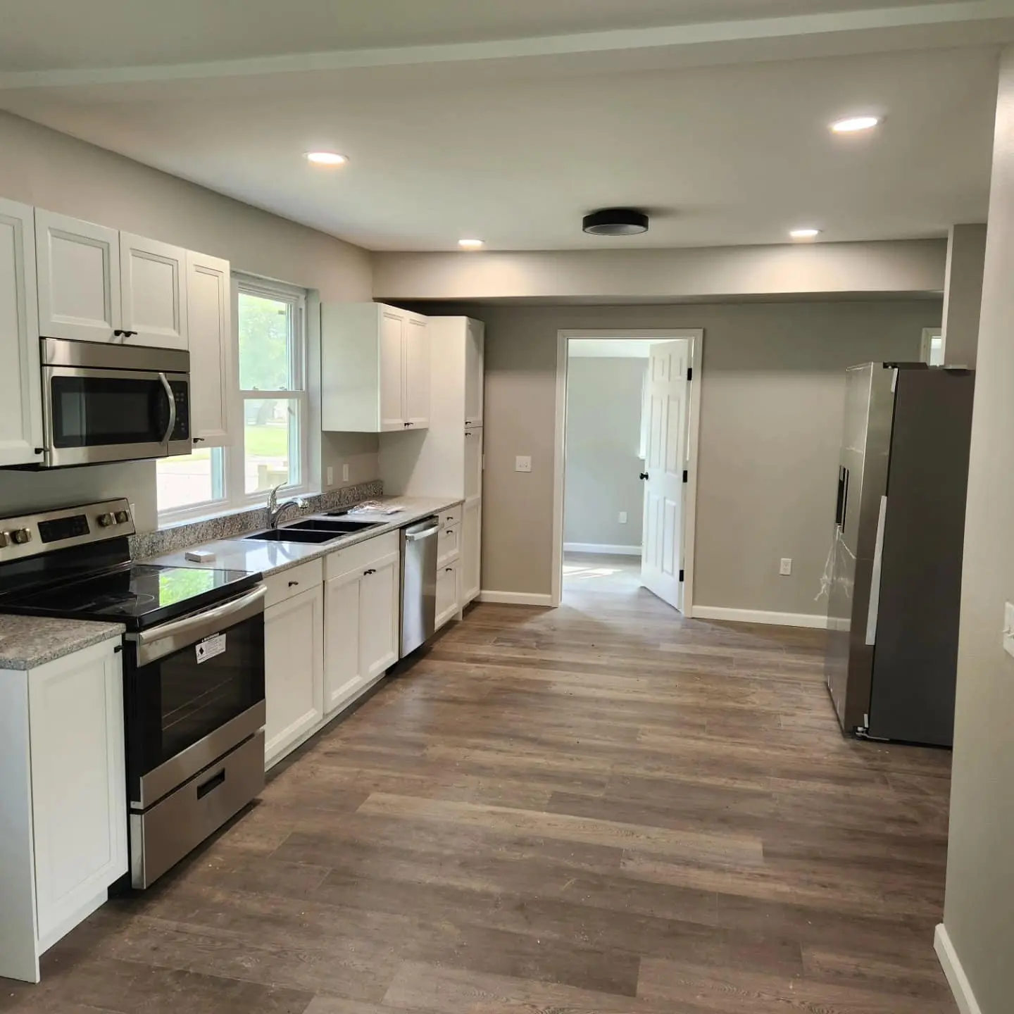 LED lights Kitchen with white cabinets and wooden floors with LED lighting