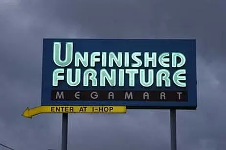 Unfinished Furniture sign at night