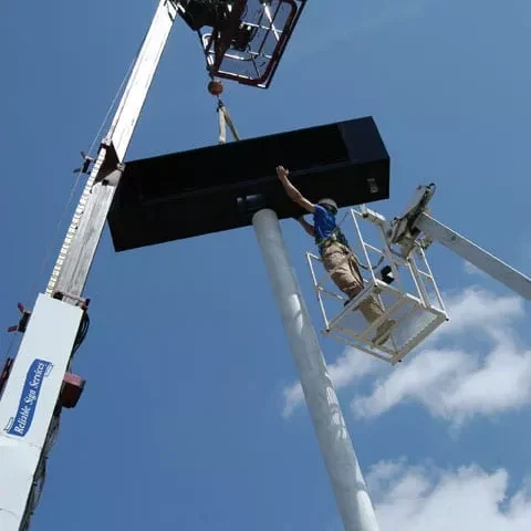 Sign install on a Crane, Reliable Signs Birmingham, Al