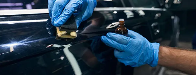 Glossy ceramic-coated car surface reflecting light in Kearny, NJ auto detailing