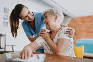 Home care healthcare professional hugging senior patient Tucson Assisted Living Care