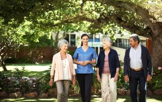 Visitors and residents walking through an assisted living community during an open house tour