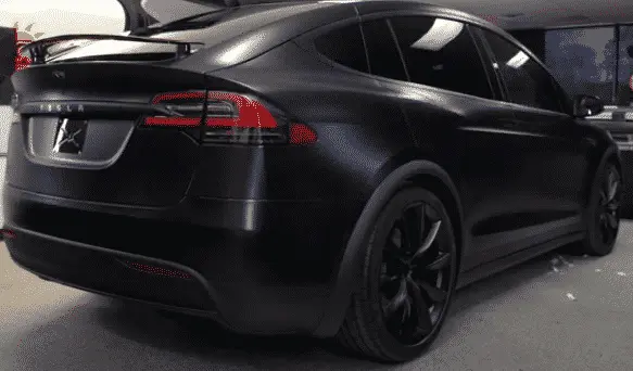 A black Model 3 Tesla with full window tint